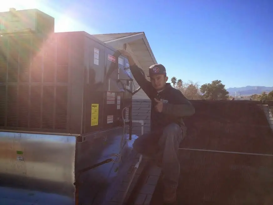HVAC technician performing HVAC Inspection on a rooftop unit in Unionville